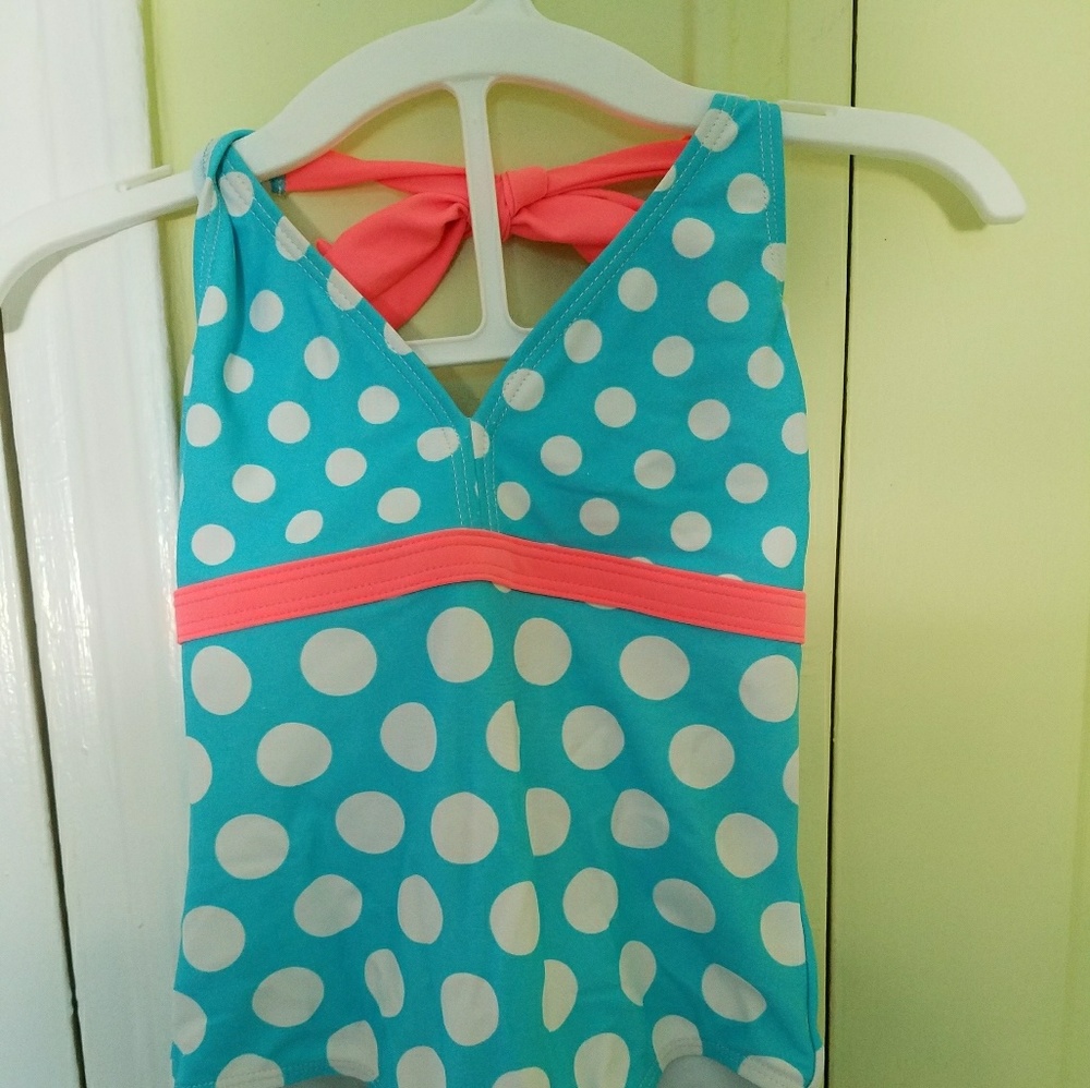 Blue one piece bathing suit with white polkadot